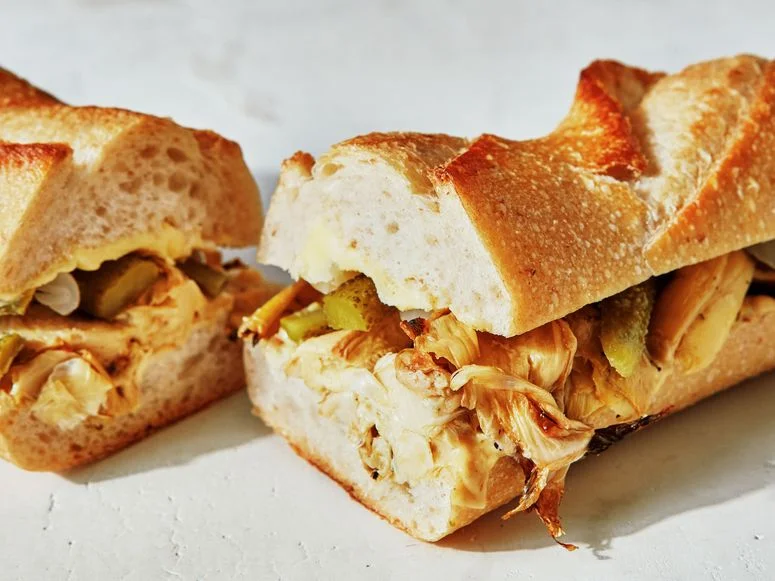Broiled artichoke hearts, sliced cornichons, pearl onions, butter, and Dijon mustard in a sliced baguette.